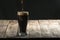 Wood table with black background and craft beer