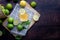 Wood table with freshly squeezed lemon juice with mint and sliced lemon