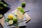 Wood table with freshly squeezed lemon juice with mint and sliced lemon