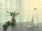 wood table with glasses and bottle of water , green weight dumbbell, glass flowerpot of plant on blurry beautiful white drape wi