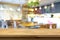 Wood table top on blur background of coffee shop (or restaurant) interior