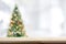 Wood table top on blur Christmas tree background