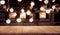 Wood table top on blurred of counter cafe shop with light bulb background