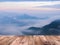 Wood table top over fog at the top of mountain