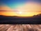 Wood table top over sun at blurry sunrise sky background