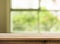 Wood table top on white abstract window glass background.