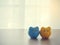 Wood table with two piggy bank on white drape texture background