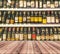 Wood table and wine Liquor bottle on shelf