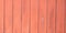 Wood texture background panorama painted coral red salmon colored