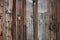 Wood texture wallpaper background, vintage darkened fence. Gray and brown boards with rusty nails.