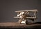 Wood toy airplane on wood table with blue clean background.