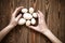 Wood toy eggs, hands, brown wood background