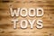 WOOD TOYS words made of wooden block letters on wooden board