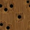 Wood veneer with a few holes from bullets, light brown color, seamless background of high resolution