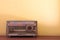 Wood vintage antique analog radio with radio dial on wooden table.