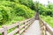 wood walkway in garden at Cheonjeyeon Falls , Jeju Island