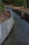 Wood walled sluice winding through wooded area leading to an old mill