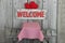 Wood welcome sign with hearts over picnic table