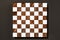 Wood and white chess board game on black background, 3d rendered