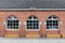 Wood windows with red bricks wall arched windows