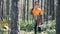 Wood worker holds a chainsaw in hands.