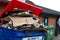 Woodbridge Suffolk UK July 07 2021: Overflowing commercial rubbish bins full of cardboard recycling sitting behind a shop that