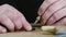 A woodcarver cuts an Orthodox ebony cross. an artisan carves a carving on a wooden cross