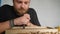 A woodcarver processes a walnut board with a chisel. artisan makes a tea tray. woodcarver art. vagatabon