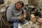 A woodcarver sits in his workshop and makes religious souvenirs from wood in Bethlehem in Palestine