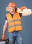 Woodcraft concept. Carpenter, woodworker, labourer, builder on busy face carries wooden beams on shoulder. Man, handyman