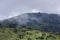 Wooded hills in the background of a stormy sky