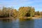 Wooded riverbank in autumn with trees in fall colors