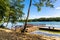 Wooded shore of Jezioro Gwiazdy lake with wooden jetty platform in Bukowo Borowy Mlyn Village near Bytow of Pomerania in Poland