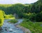 Wooded shores of the Prut River with rocky outcrops