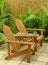 Wooden Adirondack chairs in tropical backyard