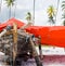 Wooden african boat on a shore covered with red canvas