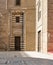 Wooden aged door surrounded by striped black and white marble decorations and stone wall, Cairo, Egypt