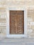 Wooden aged engraved door and exterior stone wall, Istanbul, Turkey