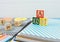 Wooden alphabet blocks on a white wooden background. Back to school, games for kindergarten, preschool education.