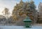 Wooden arbour covered with hoarfrost in winter garden