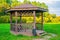 Wooden arbour in park a background of green trees