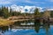 Wooden arch footbridge in Cascade Ponds park in autumn sunny day. Banff National Park, Canadian Rockies.