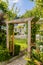 Wooden Archway in Upmarket wealthy suburban mansion house with landscaped garden