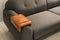 Wooden armrest table on sofa in room. Interior element