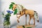 Wooden articulated dummy horse mannequin in white inflorescences with a small bouquet