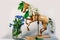 Wooden articulated dummy horse mannequin in white inflorescences with a small bouquet