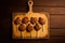 On a wooden background, a board with delectable chicken lollipops