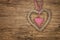 Wooden background with a braided heart