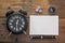 Wooden background desk with clock, paper,dice,compass and pen