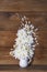 Wooden background with floral bouquet in vase. Still life